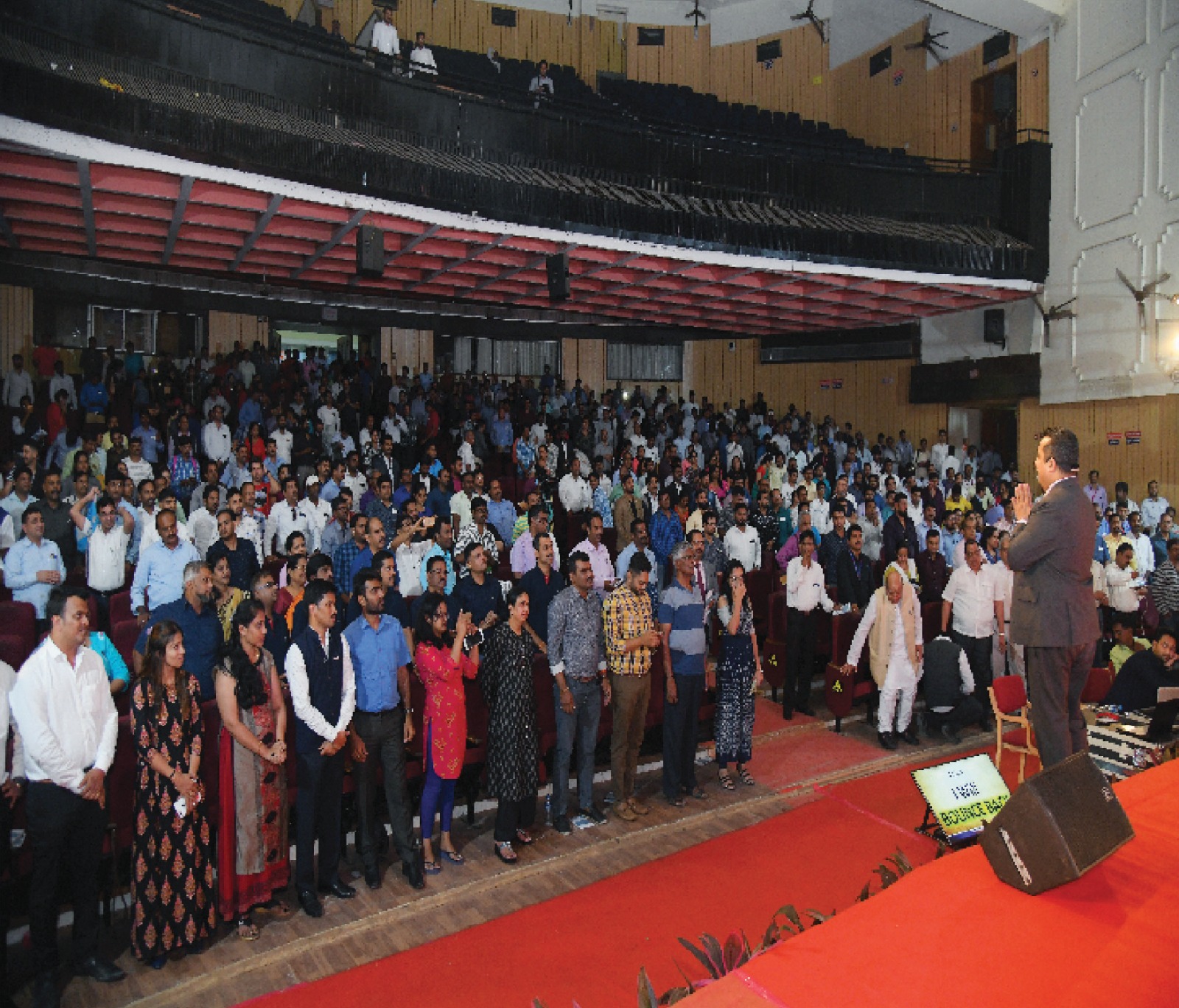 Audience standing in ovation at a corporate event